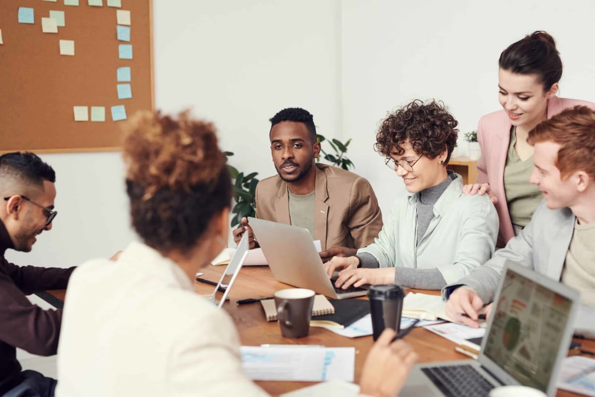 A diverse group of men and women participate in a business meeting at a conference table